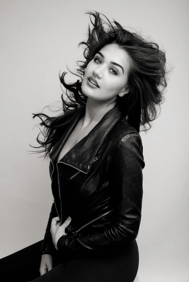 Aneesa in a leather editorial portrait.