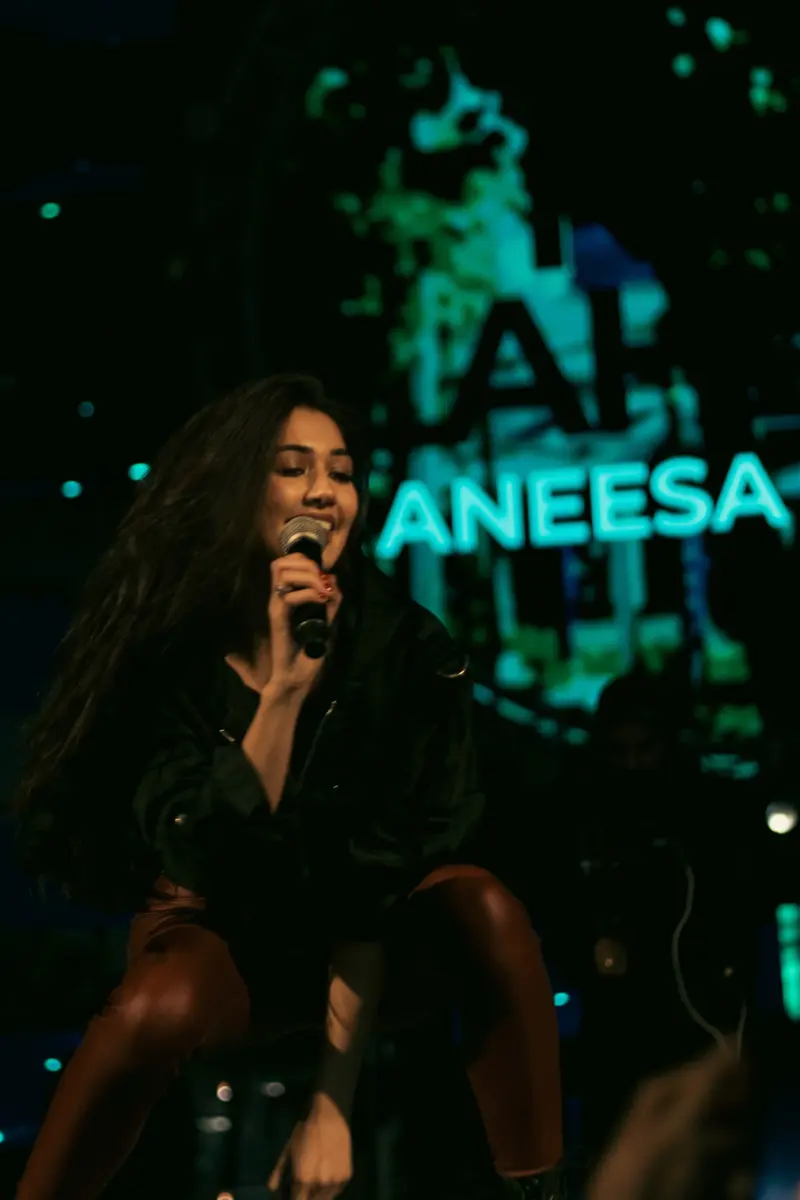 ANEESA spelled in lights behind the stage.